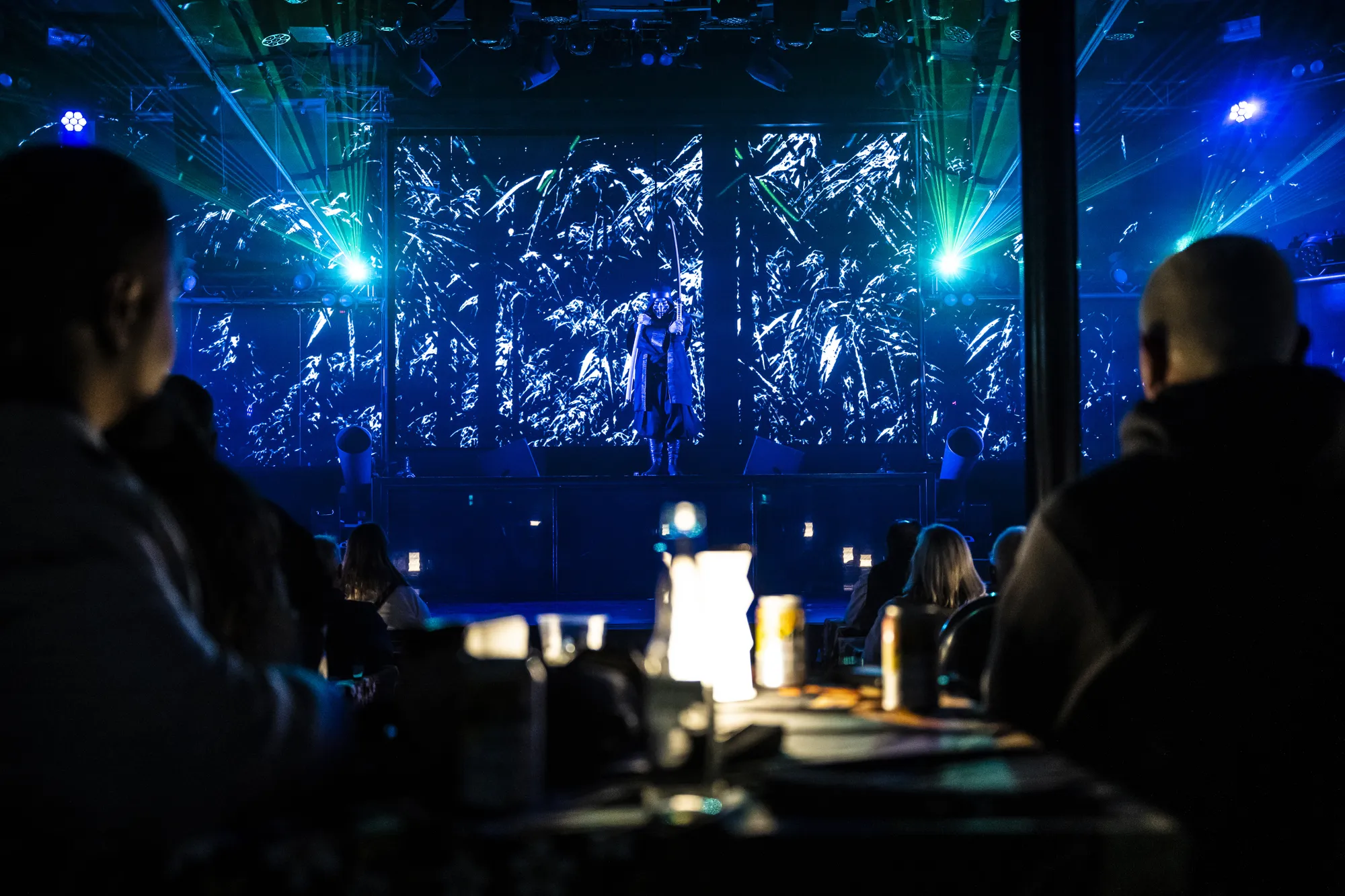 Audience and stage in blue light — Ninja + Kabuki Tokyo